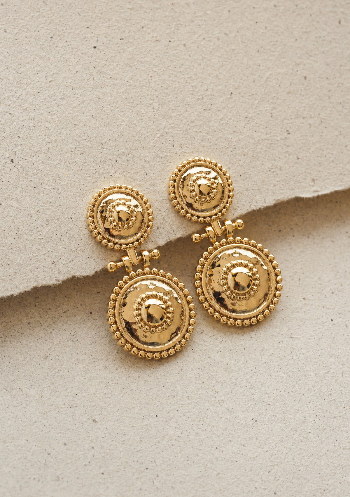 Détail des boucles d'oreilles Mémoire Solaire en or recyclé doré, double médaillon perlé au motif solaire bohème signé Namaka