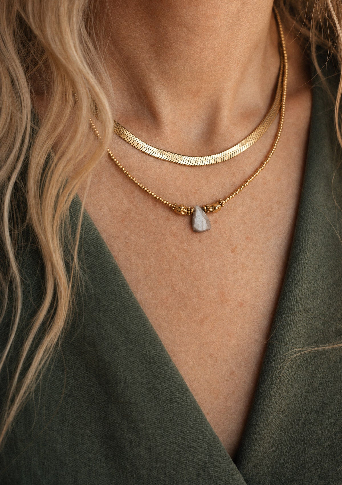 Collier chaîne serpent plate dorée porté en accumulation avec un collier Pierre de Lune brune, bijou minimaliste et féminin Namaka