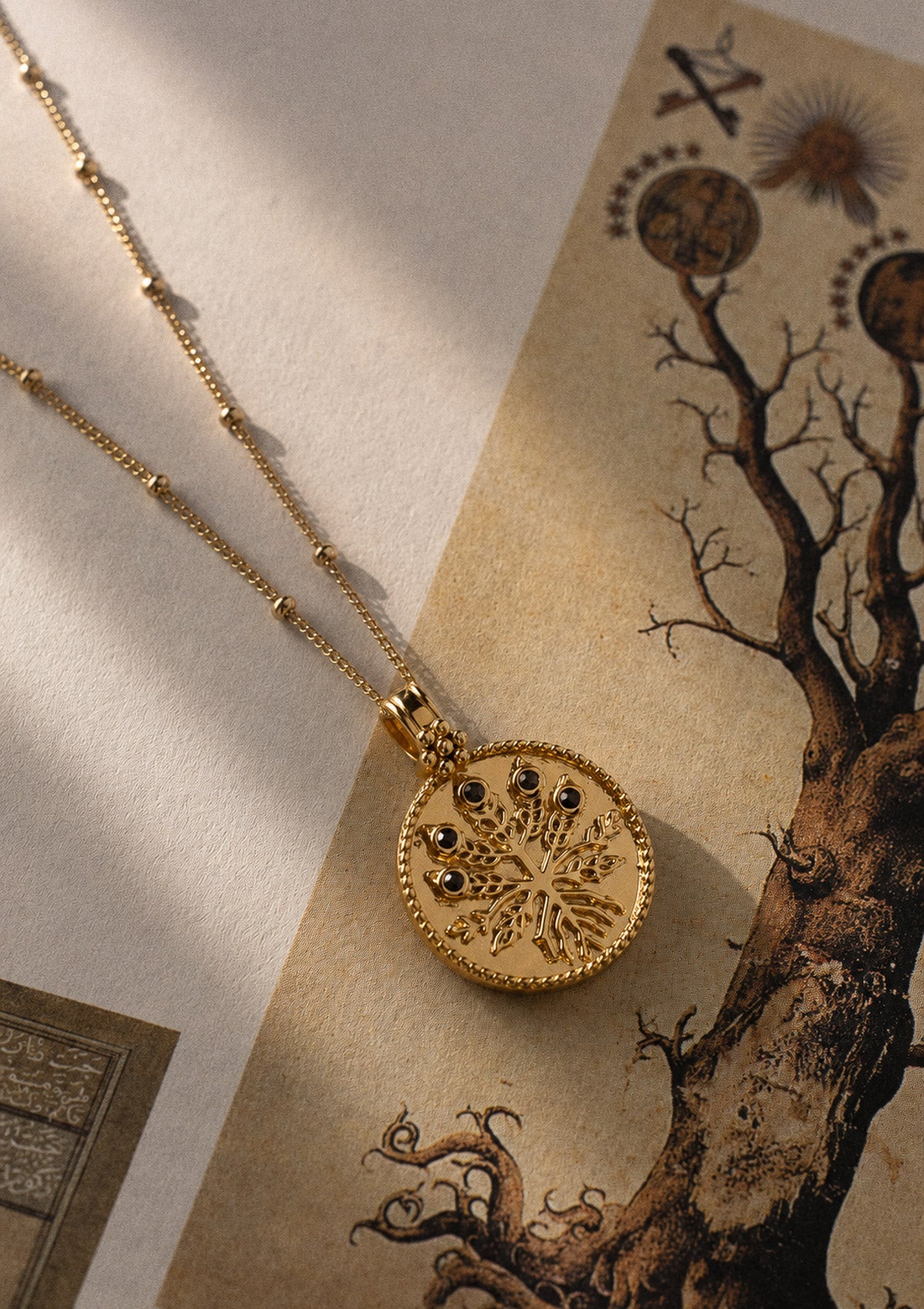 Pendentif médaillon en or recyclé 18 carats sculpté d'un arbre serti de Quartz Fumé naturel, chaîne perlée fine signé Namaka